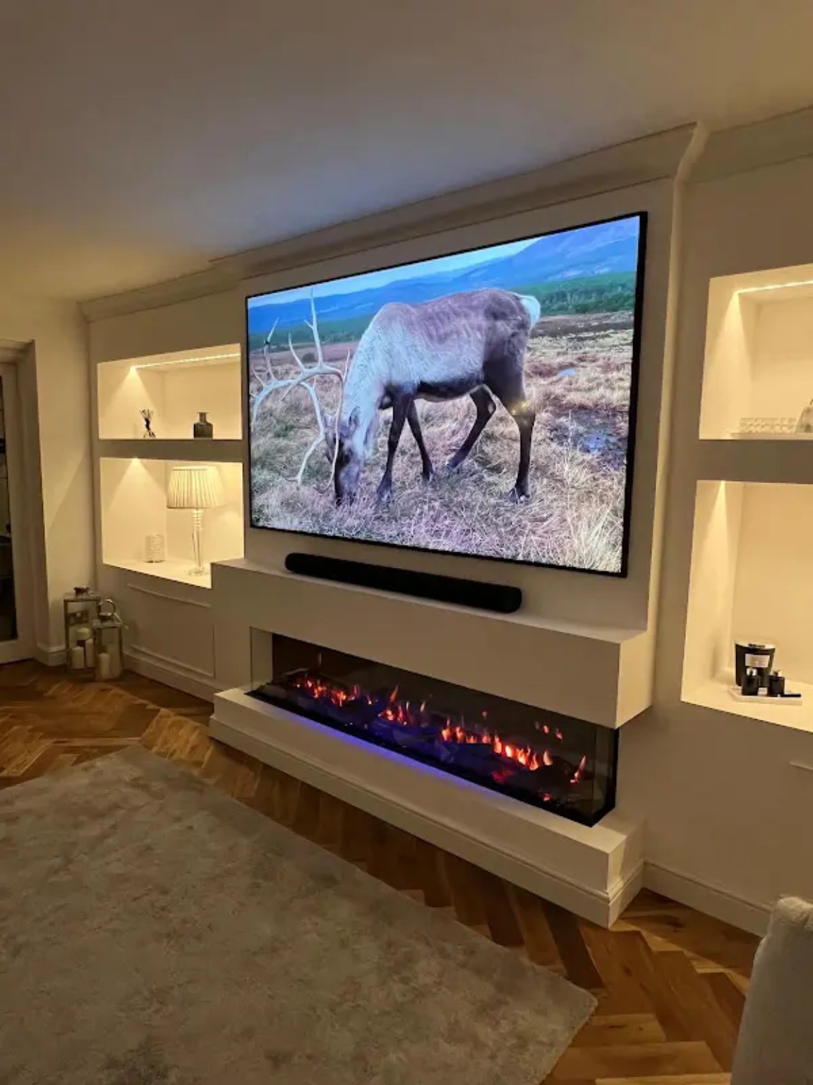 Completed media wall with large TV, long electric fire and illuminated alcoves by Ascots Fires and Flues